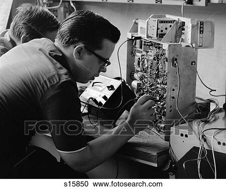 1960S Side View Of Students Working On Circuitry Panel With Small Soldering Iron View Large Photo Image Stock Image - 1960S Side View Of Students Working On Circuitry Panel With Small Soldering Iron . Fotosearch