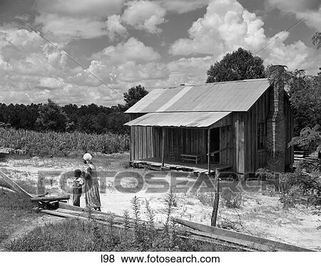 1960S Simple Wooden House African American Woman And Boy Looking In The Distance At Farm Near Greenville Alabama Summer Outdoor View Large Photo Image Stock Photo - 1960S Simple Wooden House African American Woman And Boy Looking In The Distance At Farm Near Greenville Alabama Summer Outdoor. Fotosearch