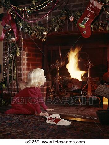 1960S Small Blonde Girl By Fireplace Decorated For Christmas Holding Stocking Nostalgia Santa View Large Photo Image Stock Photo - 1960S Small Blonde Girl By Fireplace Decorated For Christmas Holding Stocking Nostalgia Santa. Fotosearch