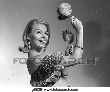 1960S Smiling Blonde Woman Shaking Noise Makers In Her Hands Wear Ruffled Halter Top Latin Music Dance Perform View Large Photo Image Stock Photo - 1960S Smiling Blonde Woman Shaking Noise Makers In Her Hands Wear Ruffled Halter Top Latin Music Dance Perform. Fotosearch
