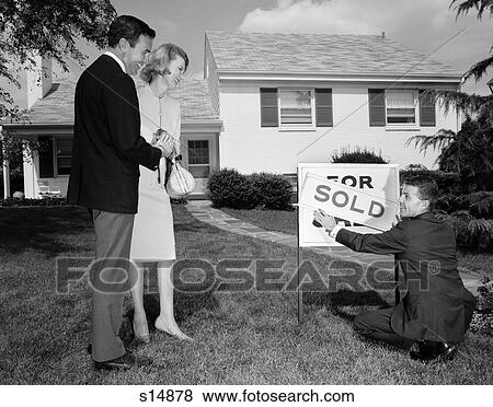 1960S Smiling Couple Standing On Front Lawn Of New House Looking Down At Realtor Putting Up Sold Sign View Large Photo Image Stock Photo - 1960S Smiling Couple Standing On Front Lawn Of New House Looking Down At Realtor Putting Up Sold Sign . Fotosearch