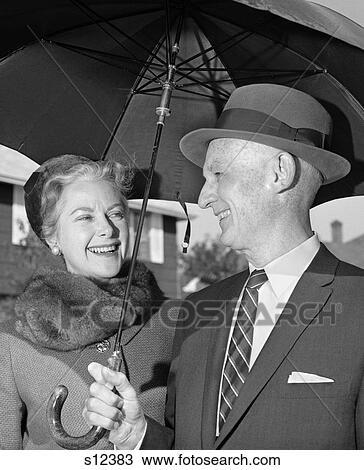 1960S Smiling Dressed-Up Elderly Couple Outside Under Large Umbrella View Large Photo Image Stock Image - 1960S Smiling Dressed-Up Elderly Couple Outside Under Large Umbrella . Fotosearch