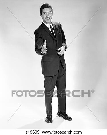1960S Smiling Full Length Portrait Man Business Man With Hand Extended In Greeting For Handshake View Large Photo Image Stock Photo - 1960S Smiling Full Length Portrait Man Business Man With Hand Extended In Greeting For Handshake . Fotosearch