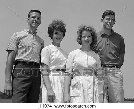 1960S Smiling Pair Of Teen Couples Standing Outdoors In Light Wind View Large Photo Image Picture - 1960S Smiling Pair Of Teen Couples Standing Outdoors In Light Wind . Fotosearch