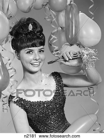 1960S Smiling Young Woman Sequined Dress Holding Noise Maker Balloons View Large Photo Image Stock Image - 1960S Smiling Young Woman Sequined Dress Holding Noise Maker Balloons . Fotosearch