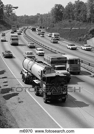 Stock Image - 1960S Tanker Truck Traveling On Busy Expressway . Fotosearch
