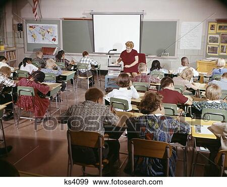 1960S Teacher With Class In Schoolroom With Audio Visual Machine Equipment View Large Photo Image Stock Photo - 1960S Teacher With Class In Schoolroom With Audio Visual Machine Equipment. Fotosearch