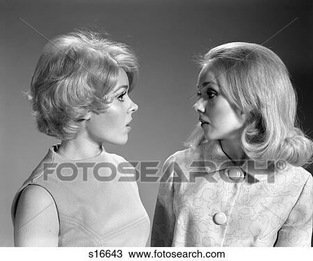 Stock Image - 1960S Two Blond Women In Profile Talking. Fotosearch