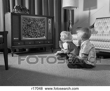 1960S Two Children Boy & Girl Sitting On Floor Watching Television View Large Photo Image Stock Photo - 1960S Two Children Boy & Girl Sitting On Floor Watching Television . Fotosearch