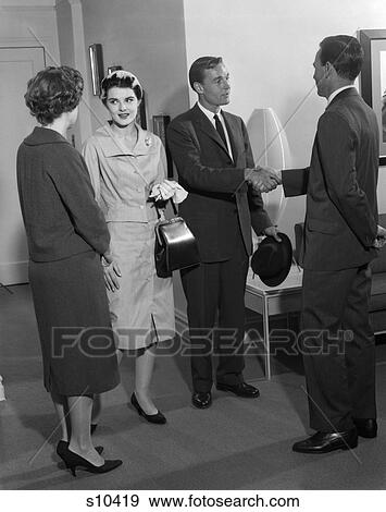 1960S Two Couples Greeting Each Other Talking Men Man Woman Women Dresses Suit Purse Pocketbook View Large Photo Image Stock Photo - 1960S Two Couples Greeting Each Other Talking Men Man Woman Women Dresses Suit Purse Pocketbook . Fotosearch