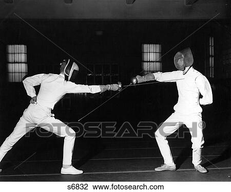 1960S Two Fencers Fencing Both Are Wearing White Uniforms And Face Masks Both Left Hands View Large Photo Image Stock Image - 1960S Two Fencers Fencing Both Are Wearing White Uniforms And Face Masks Both Left Hands . Fotosearch