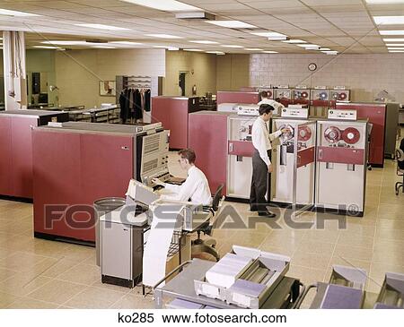 Stock Photography - 1960S Two Men In Office Working At Mainframe Reel To Reel Computers . Fotosearch