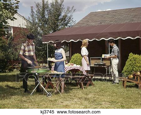 1960S Two Teenaged Couples Having Barbecue In Suburban Backyard Boy Girl View Large Photo Image Stock Photography - 1960S Two Teenaged Couples Having Barbecue In Suburban Backyard Boy Girl. Fotosearch