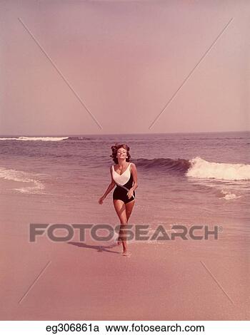 1960S Woman Bathing Suit Running Along Beach View Large Photo Image Stock Image - 1960S Woman Bathing Suit Running Along Beach. Fotosearch