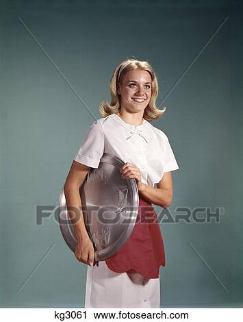 1960S Woman Dressed In White Dress Red Apron Holding Silver Tray Waitress Server View Large Photo Image Stock Image - 1960S Woman Dressed In White Dress Red Apron Holding Silver Tray Waitress Server. Fotosearch