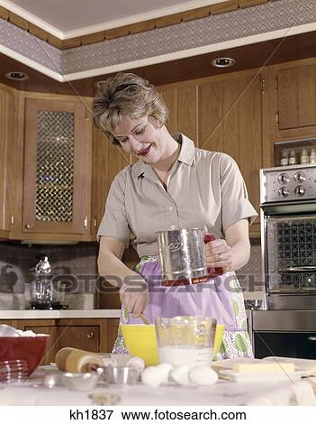 Stock Photo - 1960S Woman Housewife Baking Kitchen Using Flour Sifter. Fotosearch