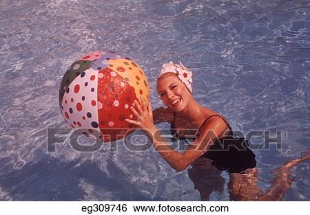 1960S Woman In Swimming Pool Holding Beach Ball View Large Photo Image Stock Photograph - 1960S Woman In Swimming Pool Holding Beach Ball. Fotosearch