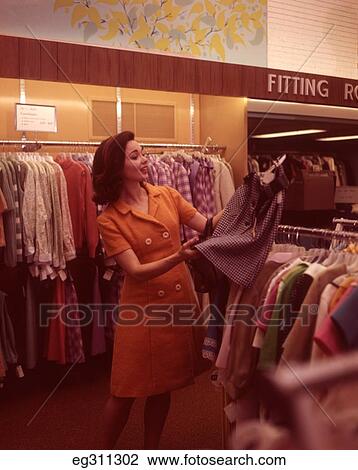 1960S Woman Looking At Skirt Clothing Store View Large Photo Image Stock Image - 1960S Woman Looking At Skirt Clothing Store. Fotosearch