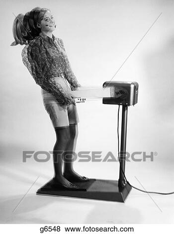 1960S Woman Massaged By Vibrating Exercise Machine View Large Photo Image Stock Photo - 1960S Woman Massaged By Vibrating Exercise Machine . Fotosearch