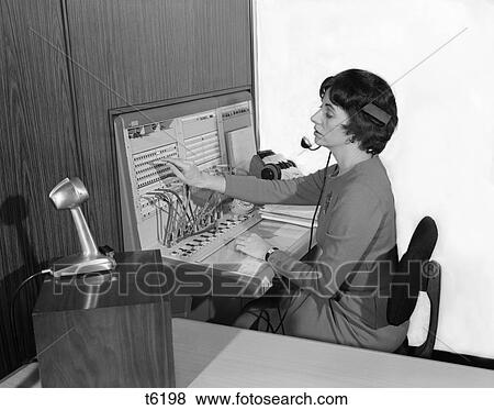 1960S Woman Office Telephone Switchboard Operator Wearing Headset Transferring Call Receptionist Answering Service Microphone View Large Photo Image Stock Photo - 1960S Woman Office Telephone Switchboard Operator Wearing Headset Transferring Call Receptionist Answering Service Microphone. Fotosearch