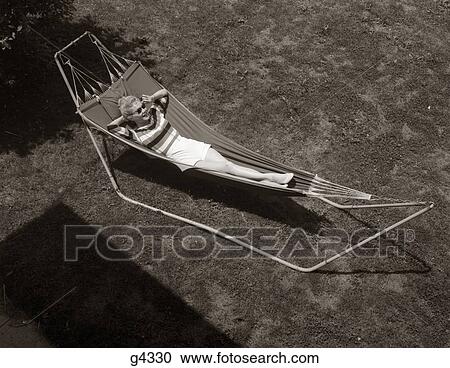 1960S Woman Relaxing On Hammock Outside View Large Photo Image Stock Image - 1960S Woman Relaxing On Hammock Outside . Fotosearch