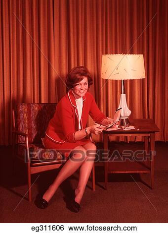 1960S Woman Sitting In A Chair Holding Check Book View Large Photo Image Stock Photograph - 1960S Woman Sitting In A Chair Holding Check Book. Fotosearch