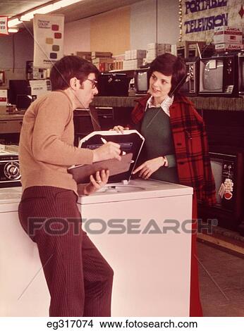 1960S Woman Talking To Salesman In Appliance Store View Large Photo Image Picture - 1960S Woman Talking To Salesman In Appliance Store. Fotosearch