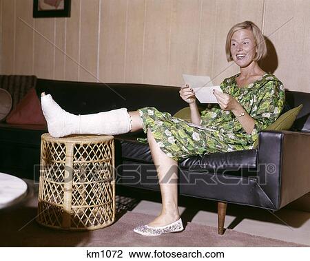 1960S Woman With Broken Leg In Cast Propped On Hamper Looking At Letter Happy Insurance Payment Basket Smiling View Large Photo Image Stock Image - 1960S Woman With Broken Leg In Cast Propped On Hamper Looking At Letter Happy Insurance Payment Basket Smiling . Fotosearch