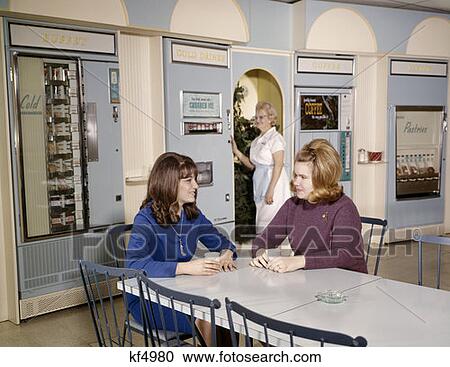 1960S Women Lunch Snack Vending Machine Room 2 Young Women At Table Paper Coffee Cups Older Woman Uniform Apron Employees View Large Photo Image Stock Image - 1960S Women Lunch Snack Vending Machine Room 2 Young Women At Table Paper Coffee Cups Older Woman Uniform Apron Employees. Fotosearch