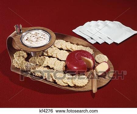 Stock Photograph - 1960S Wooden Party Snack Tray Dip Edam Cheese Crackers Napkins Toothpicks Red Background . Fotosearch