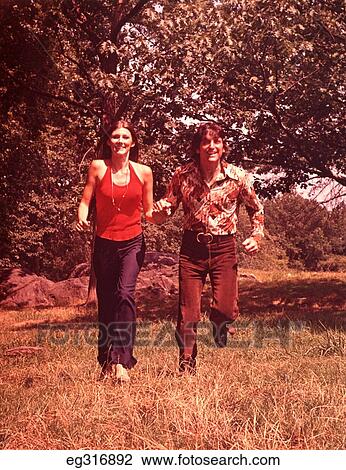 1960S Young Couple Running In Field View Large Photo Image Stock Image - 1960S Young Couple Running In Field. Fotosearch