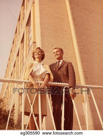 1960S Young Teen Couple Smiling Outdoors By Wrought Iron Railing And Brick Building View Large Photo Image Stock Image - 1960S Young Teen Couple Smiling Outdoors By Wrought Iron Railing And Brick Building. Fotosearch