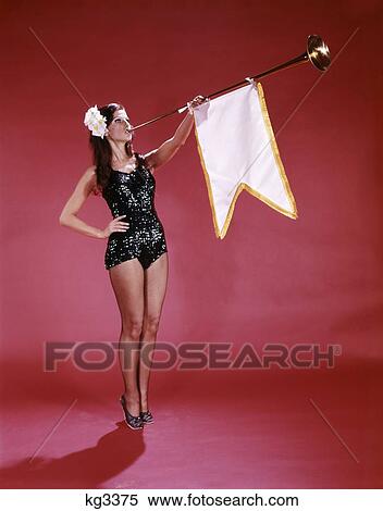 1960S Young Woman In Sequined Black Swimsuit Holding Pageant Type Trumpet With Attached Pennant Flag View Large Photo Image Stock Photography - 1960S Young Woman In Sequined Black Swimsuit Holding Pageant Type Trumpet With Attached Pennant Flag. Fotosearch