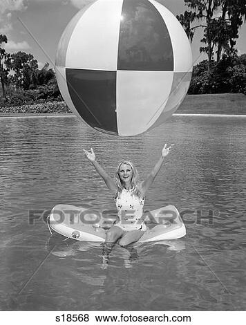 1960S Young Woman On Inflatable Raft In Pool Catching Large Beach Ball Summer Outdoor View Large Photo Image Stock Photo - 1960S Young Woman On Inflatable Raft In Pool Catching Large Beach Ball Summer Outdoor . Fotosearch