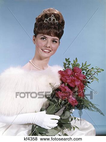 1960S Young Woman Teen Formal Dress Hold Bouquet Roses Bee Hive Hairdo Tiara Prom Beauty Queen Fashion View Large Photo Image Stock Photo - 1960S Young Woman Teen Formal Dress Hold Bouquet Roses Bee Hive Hairdo Tiara Prom Beauty Queen Fashion. Fotosearch