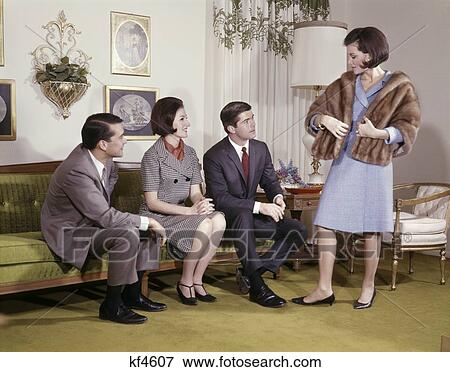 1960Ss Two Couples Men Women Living Room Couch One Woman Standing Wear Fur Stole Try On Show Off Gift New Brag View Large Photo Image Stock Photo - 1960Ss Two Couples Men Women Living Room Couch One Woman Standing Wear Fur Stole Try On Show Off Gift New Brag. Fotosearch
