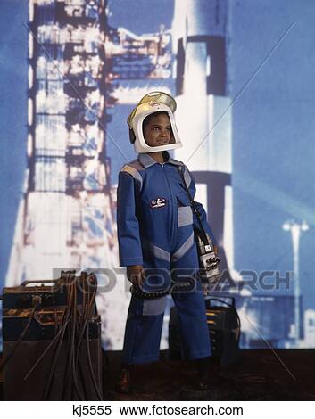 1970S 1960S African-American Boy Space Suit Costume Helmet Rocket Background Astronaut Career View Large Photo Image Stock Photography - 1970S 1960S African-American Boy Space Suit Costume Helmet Rocket Background Astronaut Career . Fotosearch