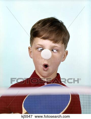 1970s 1960s Funny Cross Eyed Boy Red Shirt Ping Pong Ball Stuck On Nose Humor Stock Photo Kj5547 Fotosearch