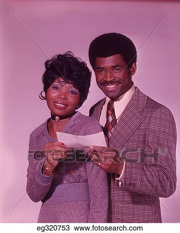 1970S African-American Couple Smiling Holding Check View Large Photo Image Stock Image - 1970S African-American Couple Smiling Holding Check. Fotosearch