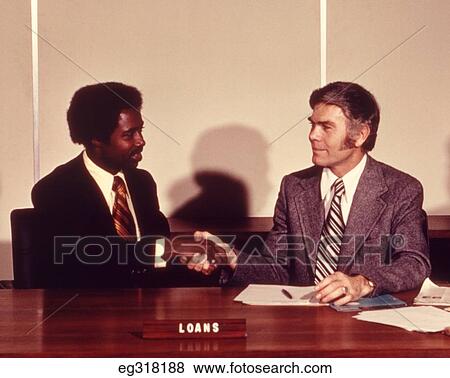 1970S African-American Man Shaking Hands With Bank Loan Officer View Large Photo Image Stock Photo - 1970S African-American Man Shaking Hands With Bank Loan Officer. Fotosearch