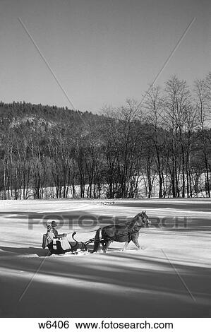 1970S Couple Riding In Cutter Sleigh Behind A Single Horse In Knee Deep Snow North Conway Vermont View Large Photo Image Stock Photograph - 1970S Couple Riding In Cutter Sleigh Behind A Single Horse In Knee Deep Snow North Conway Vermont . Fotosearch