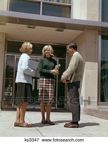 Stock Photo - College Students Talking Books 1960 1960S Retro. Fotosearch