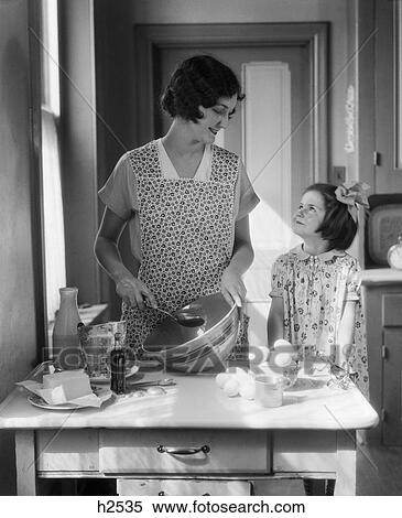 1920s 1930s mother with mixing bowl in kitchen with daughter View Large Photo Image Stock Photography - 1920s 1930s mother with mixing bowl in kitchen with daughter. Fotosearch
