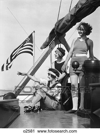 1920s group of three women upon deck of sailboat pointing to left under an american flag View Large Photo Image Stock Image - 1920s group of three women upon deck of sailboat pointing to left under an american flag. Fotosearch