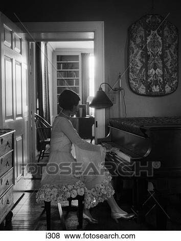 1920s woman sitting playing piano pianist View Large Photo Image Stock Photo - 1920s woman sitting playing piano pianist. Fotosearch