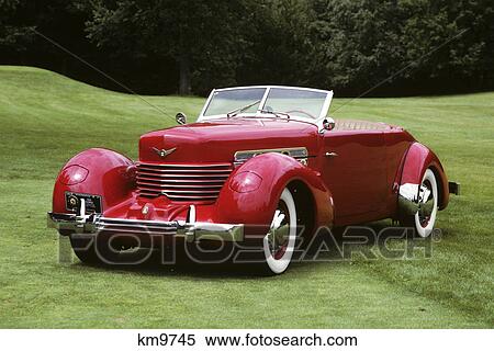 1930s 1936 red cord convertible automobile top down on green grassy lawn View Large Photo Image Stock Photography - 1930s 1936 red cord convertible automobile top down on green grassy lawn. Fotosearch