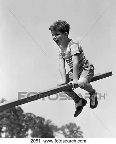 1930s 1940s excited boy on seesaw playing View Large Photo Image Stock Image - 1930s 1940s excited boy on seesaw playing. Fotosearch