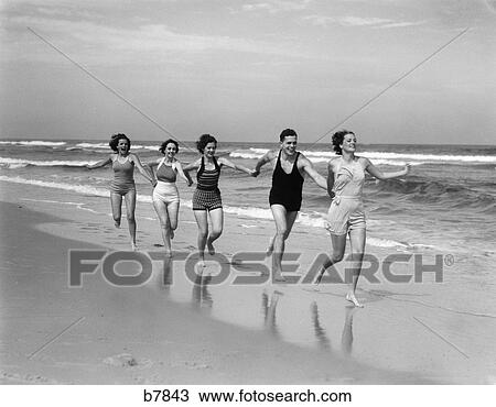 1930s four women and one man running on beach holding hands View Large Photo Image Stock Image - 1930s four women and one man running on beach holding hands. Fotosearch