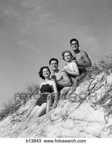 1930s group young men women posed on beach sand dune View Large Photo Image Stock Image - 1930s group young men women posed on beach sand dune. Fotosearch