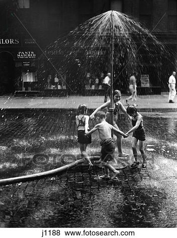 1930s inner city children playing in spray from fire hydrant water sprinkler View Large Photo Image Stock Photo - 1930s inner city children playing in spray from fire hydrant water sprinkler. Fotosearch